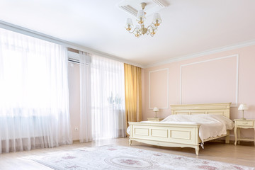 White apartment interior design bedroom with classic furniture, curtains, modern style in chisinau, cenral district, moldova