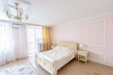 Fototapeta na wymiar White apartment interior design bedroom with classic furniture, curtains, modern style in chisinau, cenral district, moldova