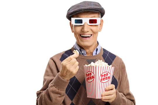 Senior wearing a pair of 3D glasses and having popcorn