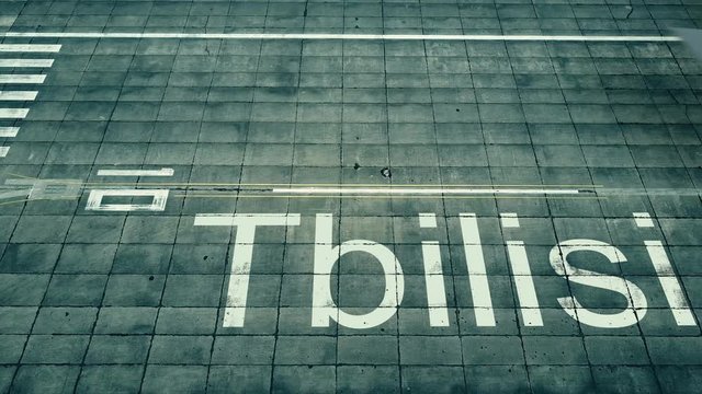 Aerial view of big airplane arriving to Tbilisi airport. Travel to Georgia conceptual intro animation
