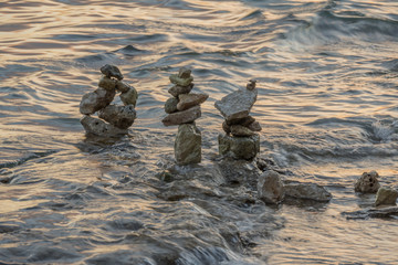 stone zen sculptures in sea at beach