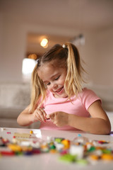 Fototapeta premium Little girl playing at home.