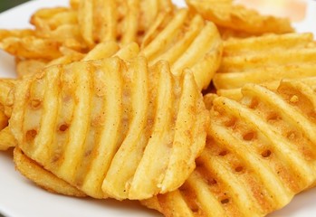 Potato slices in grid cut on white background