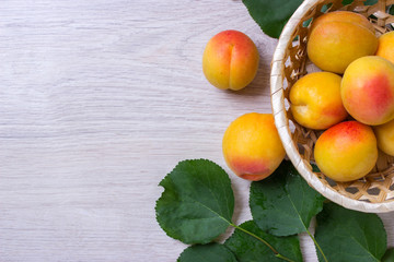 Fresh apricots in the basket On a wooden table