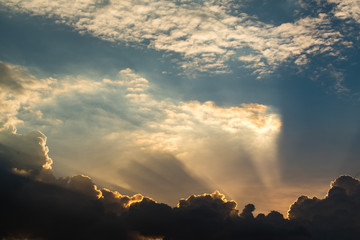 Sun rays through clouds like an dramatic explosion , power nature background.