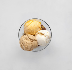 ice cream in balls in a glass on a light background. top view