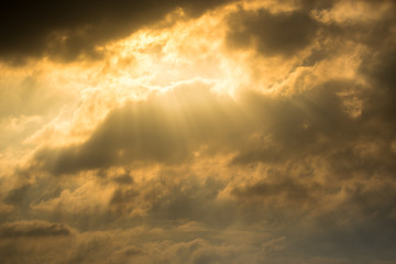 Naklejka na ściany i meble Sun rays through clouds like an dramatic explosion