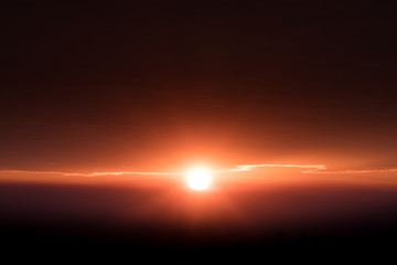 Sun at skyline shine ray rim light on edge of cloud