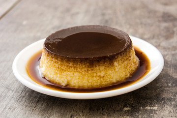 Creme caramel. Egg pudding on wooden table
