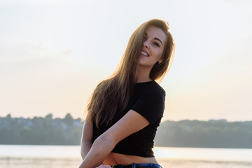 Fototapeta na wymiar Summer spring portrait of young beautiful woman smile in the park sunset