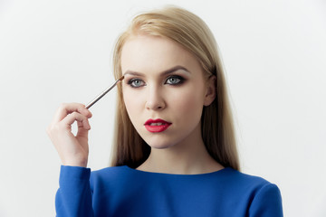 Fototapeta premium Woman with makeup brush applying eyeshadow