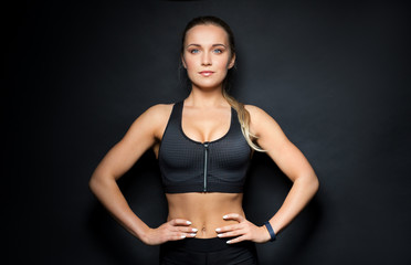 young woman in black sportswear posing