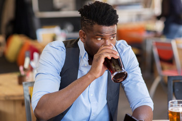man drinking draught beer at bar or pub