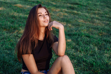 Fototapeta premium Summer spring portrait of young beautiful woman smile in the park sunset