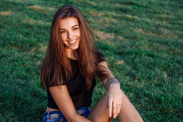 Summer spring portrait of young beautiful woman smile in the park sunset