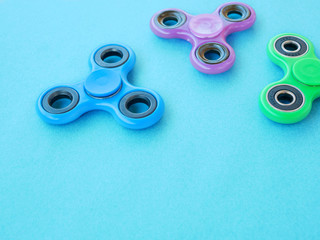 Popular colourful fidget spinner toy on a colored background