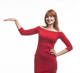 Young happy woman showing by hands on a gray background. Ideal for banners, registration forms, presentation, landings, presenting concept.