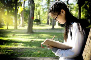Asian girl read her book in natural park