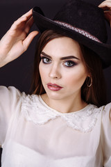 Portrait of a beautiful woman in cowboy's hat