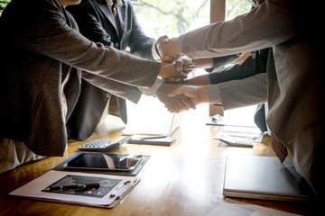 Hand together in the business office show teamwork