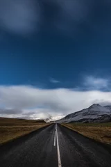 Keuken spatwand met foto Starry night and empty driving road in Iceland with snowy mountains on the background © anastasianess