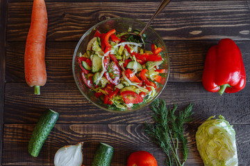 Vegetables for salad. Tomato cabbage onion cucumber carrot pepper on a wooden board