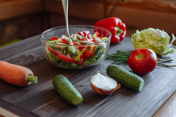 Vegetables for salad. Tomato cabbage onion cucumber carrot pepper on a wooden board