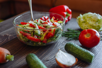 Vegetables for salad. Tomato cabbage onion cucumber carrot pepper on a wooden board