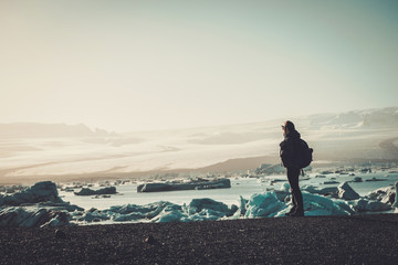 Woman explorer lookig at Jokulsarlon lagoon, Iceland.