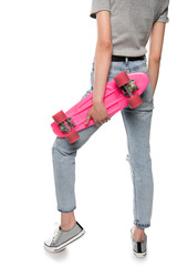 Cropped shot of girl holding skateboard and posing isolated on white