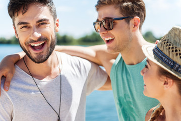 Cheerful youthful friends having fun on beach