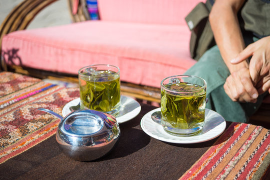 Tea cups with Coca leaves infusion known as "Mate de Coca", typical drink of local people leaving at high altitude on the Andes in Peru and Bolivia.