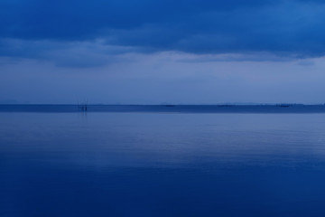 Blue sky hour after sunset. Dusk sea and clouds scape.