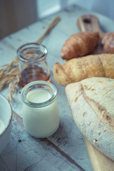 fresh bread and baked goods on wooden chopping board, rustic style