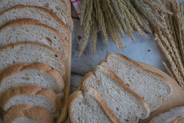 fresh bread and baked goods on wooden chopping board, rustic style