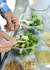young man preparing a prepared salad