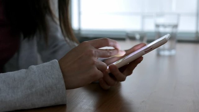 Woman using cellphone at home office