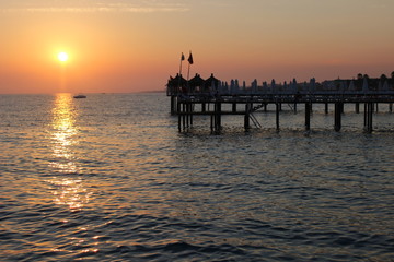 Fototapeta na wymiar sunset on the beach, romantic time, lovelu sky, ocean, dusk, clouds, romantic, lovely , bridge, colors, 