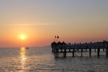 Fototapeta na wymiar sunset on the beach, romantic time, lovelu sky, ocean, dusk, clouds, romantic, lovely , bridge, colors, 