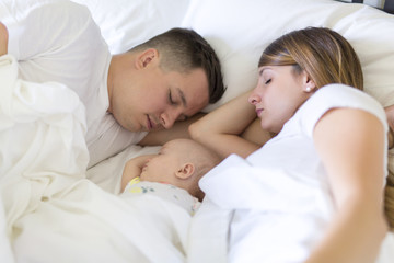 Portrait of parent with her 3 month old baby in bedroom sleeping