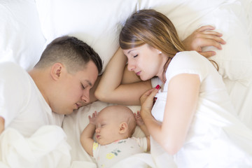 Portrait of parent with her 3 month old baby in bedroom sleeping