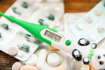 Thermometer and meds bottles with blanked labels