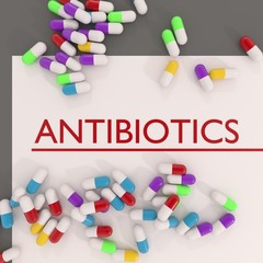 3d illustration of antibiotics title or header with some colorful pills on white sheet of paper top view