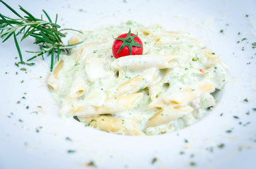 Pasta penne with chicken meat and basil
