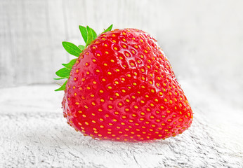 Fresh strawberries on white wooden table.