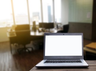 Laptop computer with white blank screen on wooden table with blurred office background with sunlight effect, working business in office, online social media technology, searching data concept
