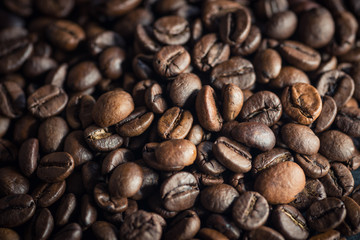 Roasted coffee beans on dark background. Selective focus.