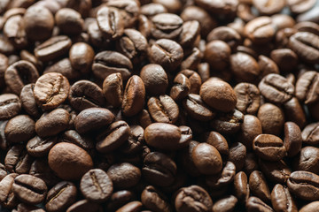 Roasted coffee beans on dark background. Selective focus.