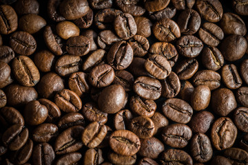 Roasted coffee beans on dark background. Selective focus.