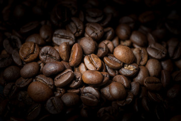 Roasted coffee beans on dark background. Selective focus.
